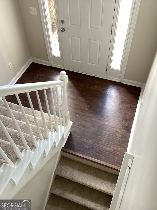 staircase with hardwood / wood-style floors