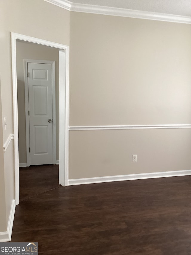 unfurnished room with crown molding and dark hardwood / wood-style flooring