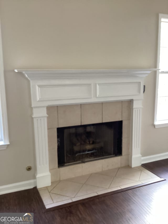 room details featuring hardwood / wood-style floors and a tile fireplace