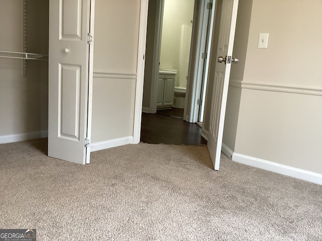 unfurnished bedroom featuring a closet and carpet flooring