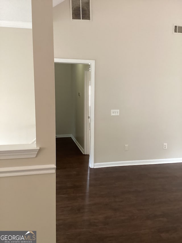 hallway with ornamental molding and dark hardwood / wood-style floors