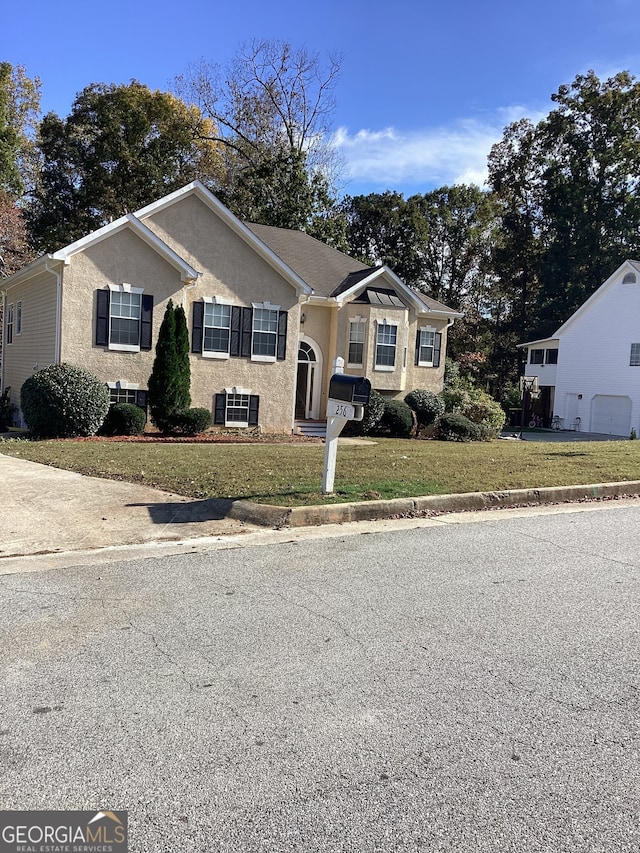 raised ranch with a front lawn