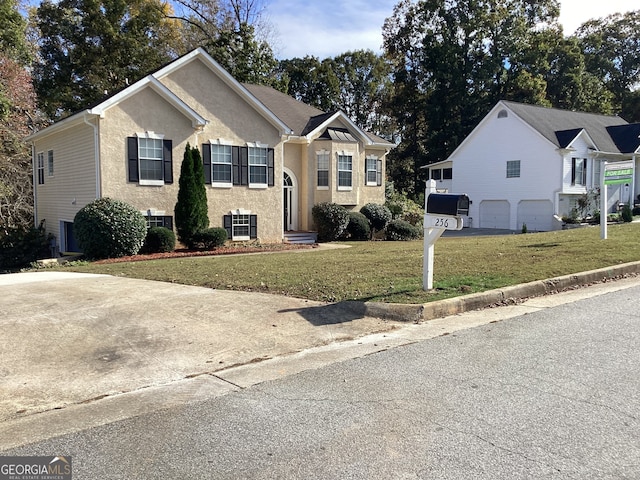 bi-level home featuring a garage and a front lawn