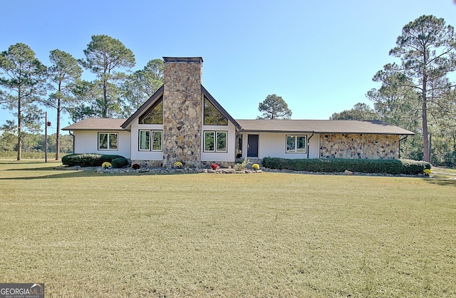 view of front of home with a chimney and a front yard