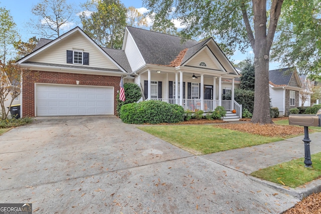 view of front of house with a garage, a front yard, and a porch