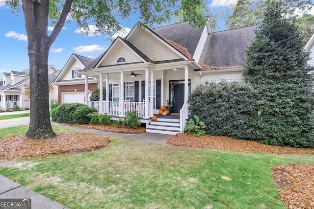 view of front of property featuring a garage, a front yard, covered porch, and ceiling fan