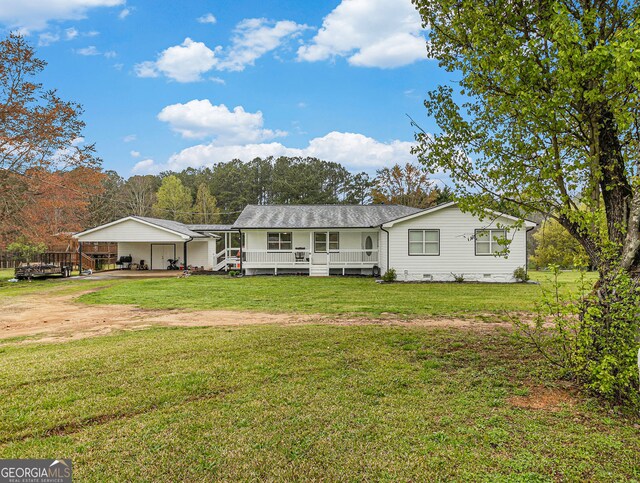 view of front facade featuring dirt driveway, a porch, crawl space, a front lawn, and a carport