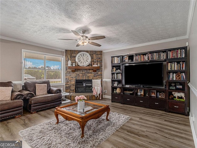 living room with ceiling fan, hardwood / wood-style floors, crown molding, and a textured ceiling