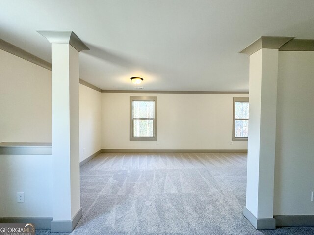 carpeted spare room featuring a tray ceiling, ceiling fan, and crown molding