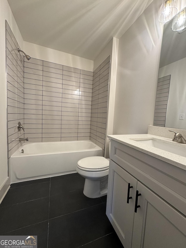 full bathroom with tile patterned flooring, vanity, toilet, and tiled shower / bath