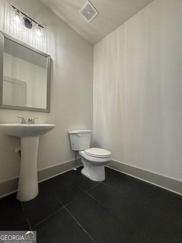 bathroom with tile patterned flooring and toilet