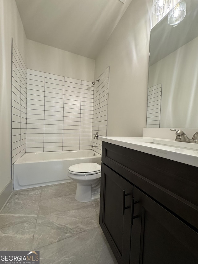 full bathroom with vanity, tiled shower / bath combo, and toilet