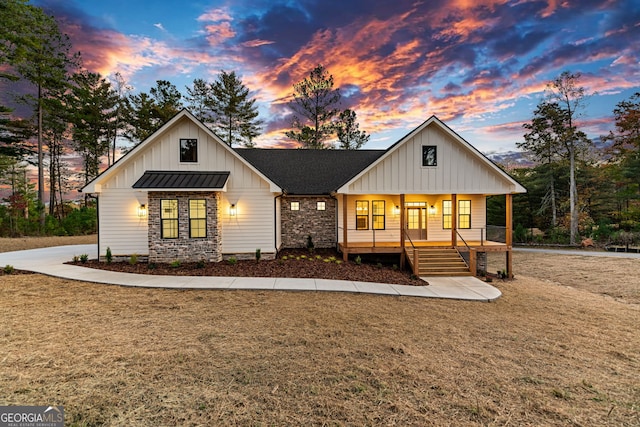 modern farmhouse featuring a yard and covered porch