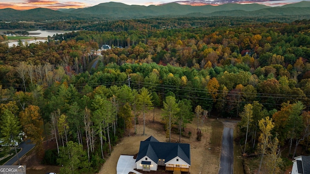 aerial view at dusk featuring a mountain view