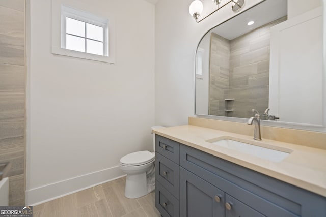 bathroom featuring toilet and vanity