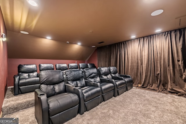 home theater room with vaulted ceiling and carpet floors