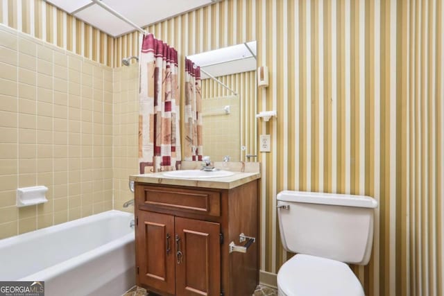 full bathroom featuring shower / bath combo, vanity, and toilet