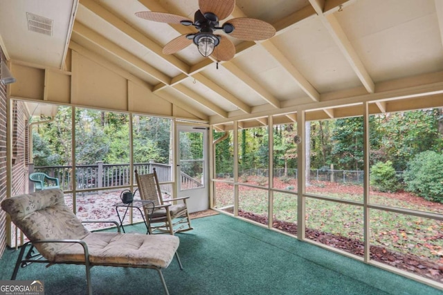 unfurnished sunroom with lofted ceiling with beams and ceiling fan