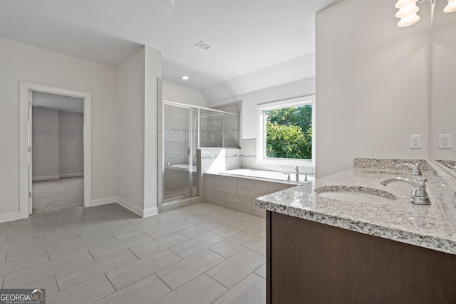 bathroom featuring vanity, vaulted ceiling, and separate shower and tub