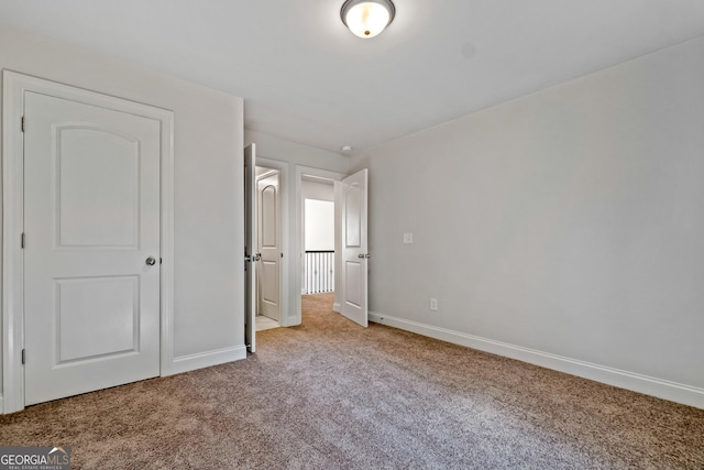 unfurnished bedroom with light colored carpet