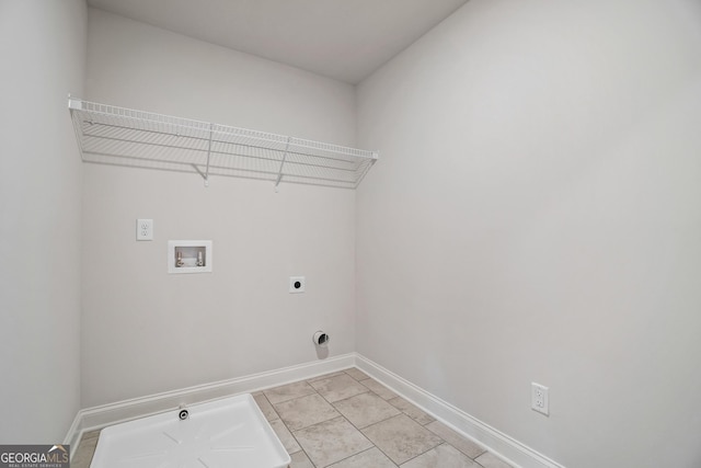 clothes washing area with hookup for an electric dryer, light tile patterned floors, and washer hookup