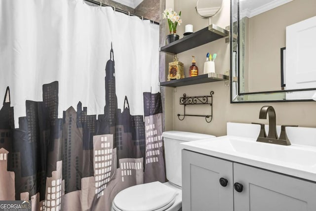 bathroom with vanity, toilet, and ornamental molding