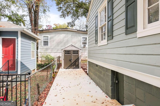 view of side of home with a storage unit