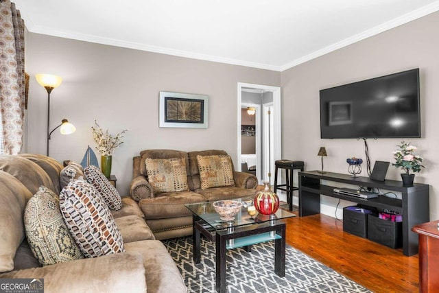 living room with hardwood / wood-style floors and crown molding