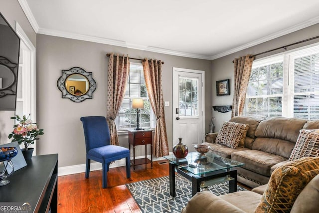 living room with dark hardwood / wood-style flooring, a wealth of natural light, and crown molding