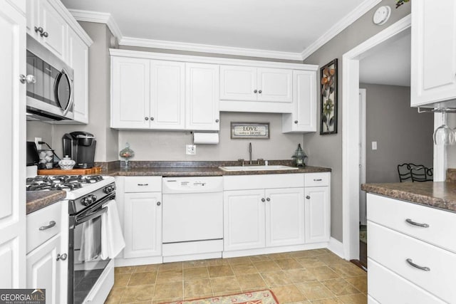 kitchen featuring white appliances, white cabinetry, sink, and ornamental molding