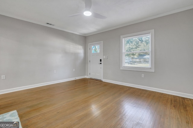 entryway featuring hardwood / wood-style floors, ceiling fan, and ornamental molding