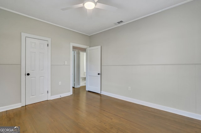 unfurnished bedroom with hardwood / wood-style flooring, ceiling fan, and crown molding