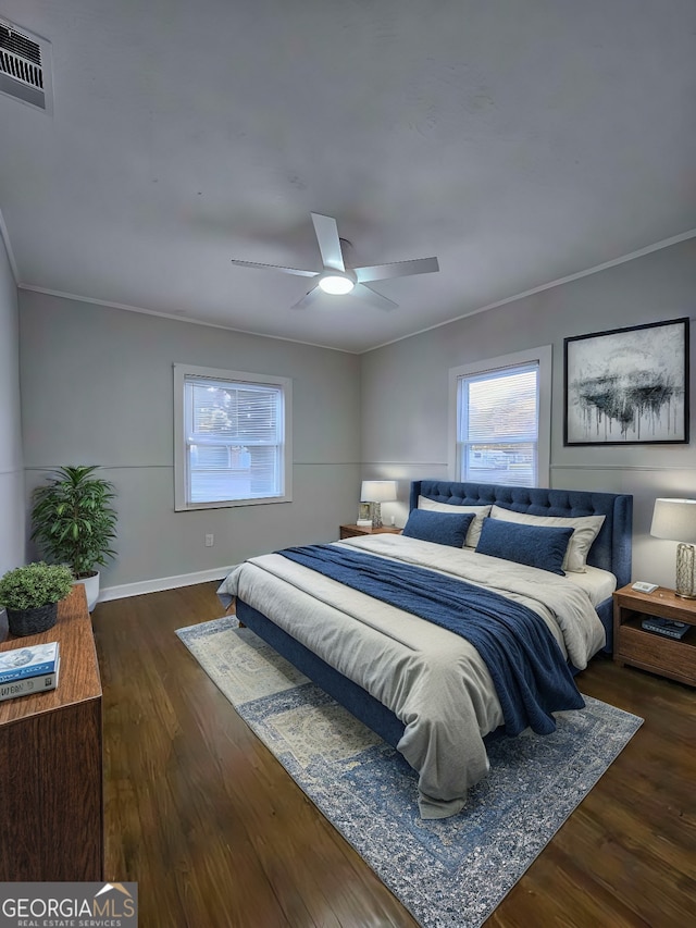 bedroom featuring ceiling fan, dark hardwood / wood-style floors, and crown molding