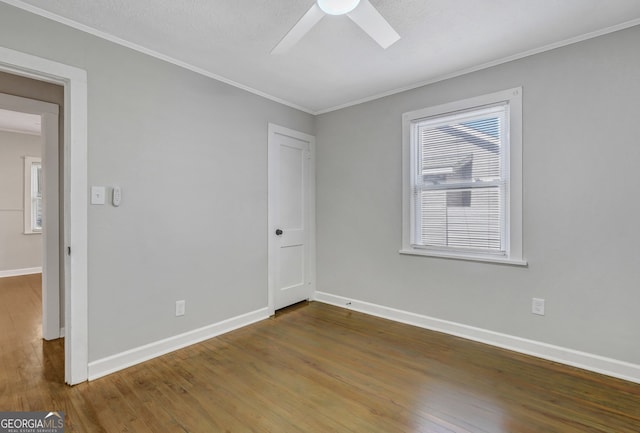 empty room featuring wood-type flooring, a textured ceiling, ceiling fan, and crown molding