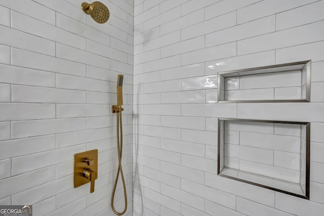 bathroom with a tile shower