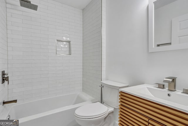 full bathroom with vanity, toilet, and tiled shower / bath