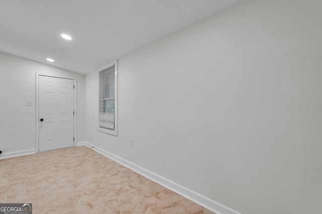 spare room featuring lofted ceiling