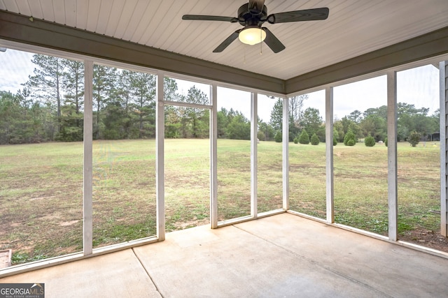 unfurnished sunroom featuring wooden ceiling and ceiling fan