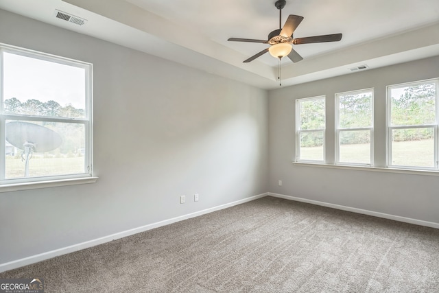 carpeted spare room featuring ceiling fan