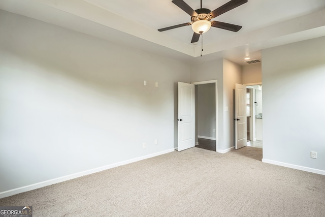 unfurnished bedroom with ceiling fan and light colored carpet