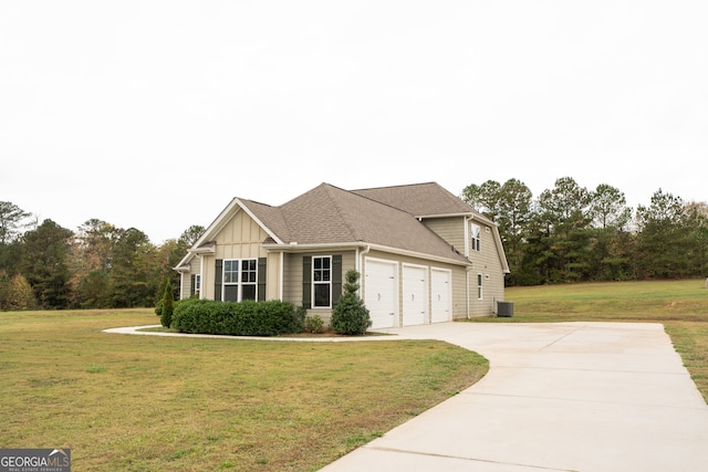 view of front of house with a garage and a front lawn