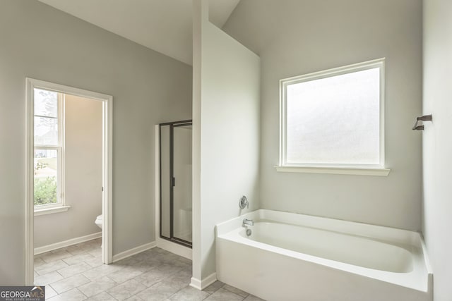 bathroom with shower with separate bathtub, vaulted ceiling, tile patterned floors, and plenty of natural light