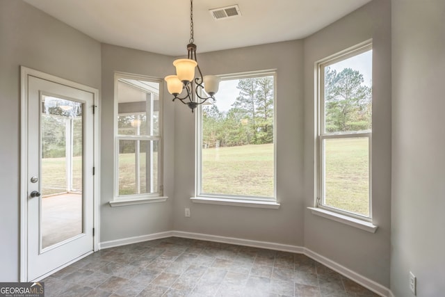 unfurnished dining area with an inviting chandelier