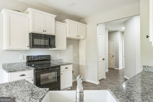 kitchen featuring black appliances, tile patterned floors, stone counters, sink, and white cabinets