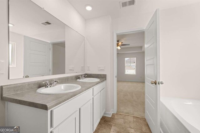 bathroom with ceiling fan and vanity