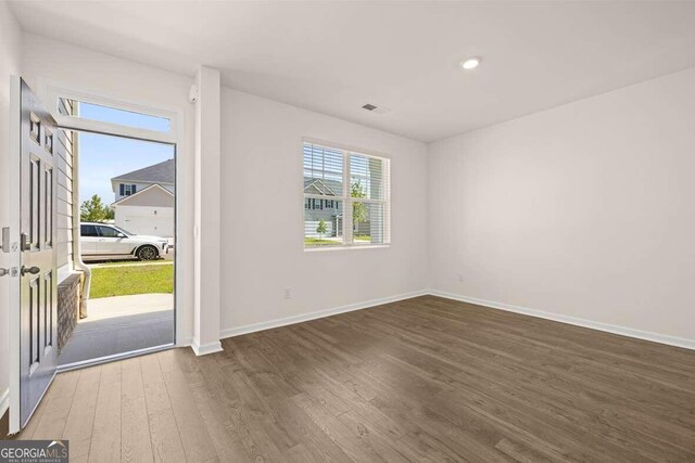 unfurnished room featuring wood-type flooring