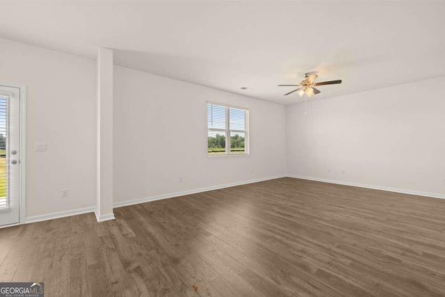 empty room featuring ceiling fan and dark hardwood / wood-style floors