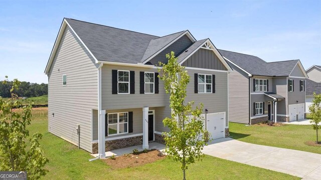 view of front of property with a front lawn and a garage