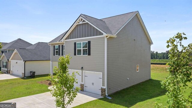 view of home's exterior with a yard and a garage