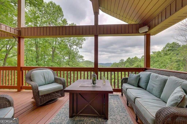 wooden terrace featuring outdoor lounge area